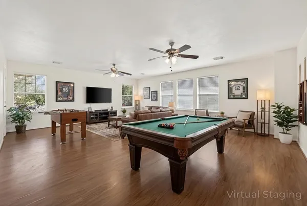 a view of room with wooden floor and ceiling fan