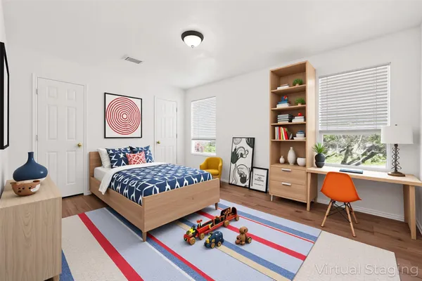 a spacious bedroom with a bed and a window
