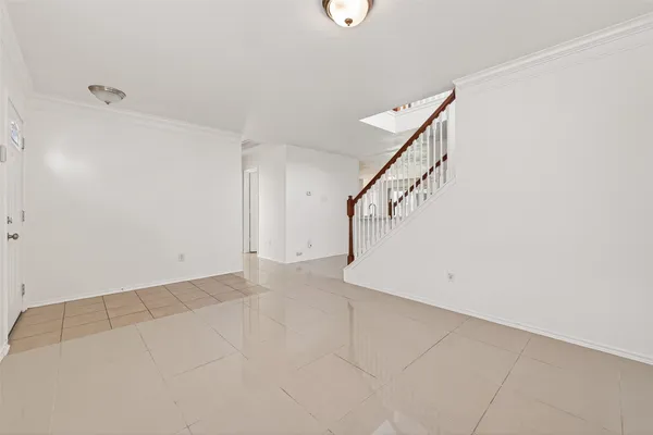 a view of empty room with a fireplace and wooden floor