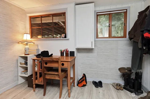 a view of a workspace with furniture and a window