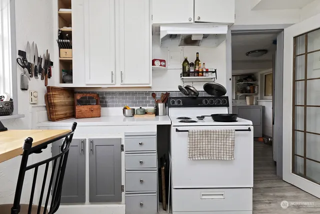a kitchen with a stove and a refrigerator