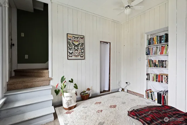 a bedroom with a bed and a book shelf