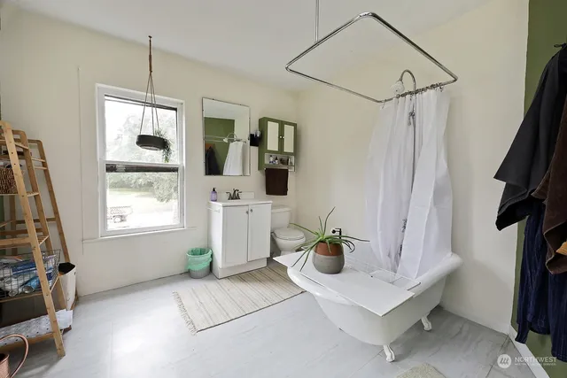 a living room with furniture a flat screen tv and a window