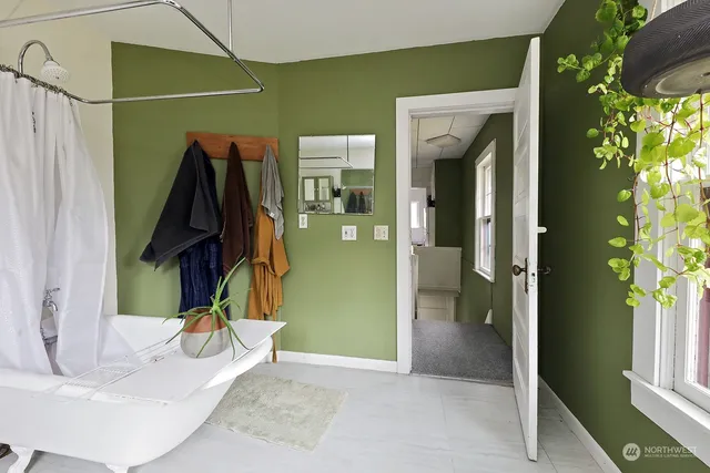 a view of a livingroom with wooden floor and windows