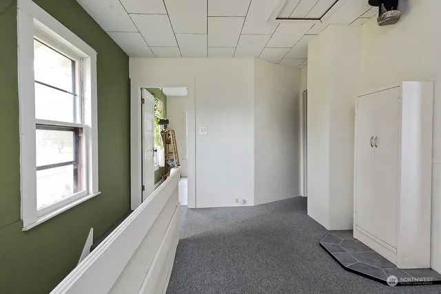 a view of a livingroom with furniture and a window