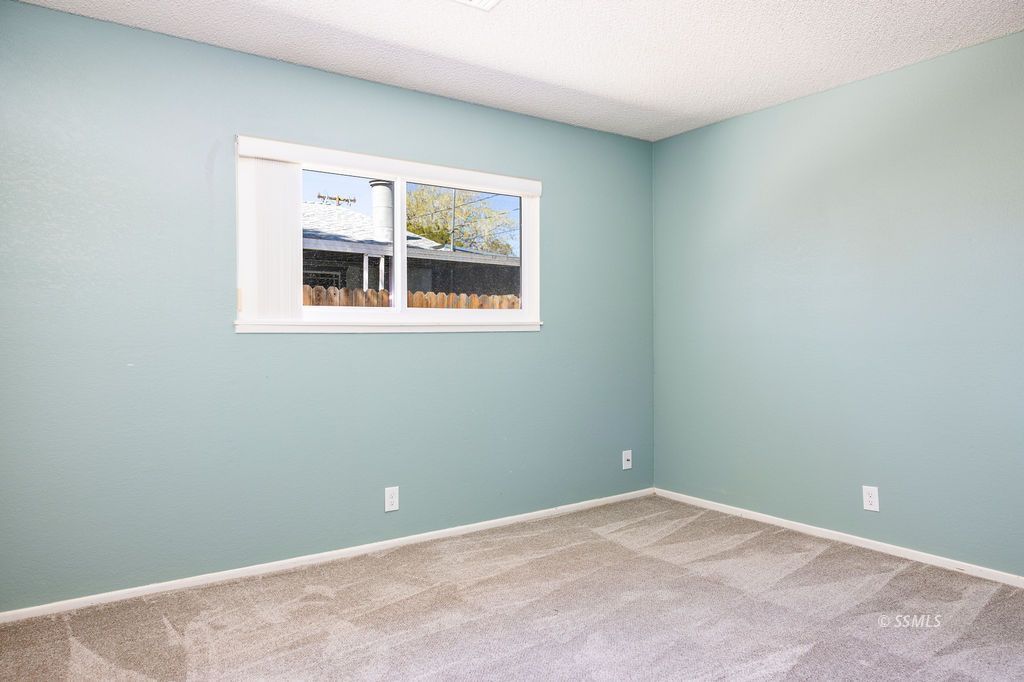 1144 West Benson Avenue Ridgecrest, CA 93555 - Photo 18 of 32 an empty room with a window
