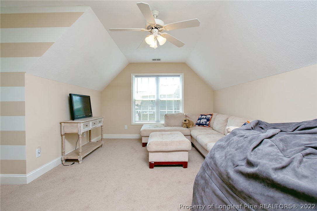 71 Germantown Road Cameron, NC 28326 - Photo 22 of 36 a spacious bedroom with a bed and a chandelier