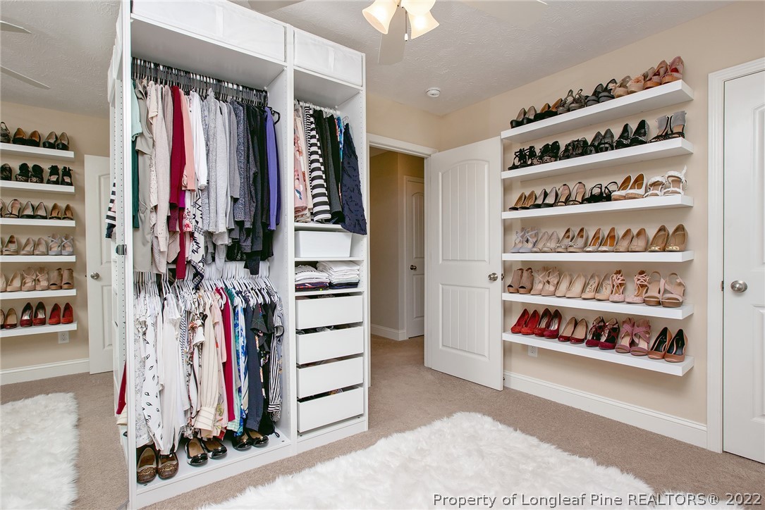 71 Germantown Road Cameron, NC 28326 - Photo 29 of 36 a view of walk in closet with clothes and shoes