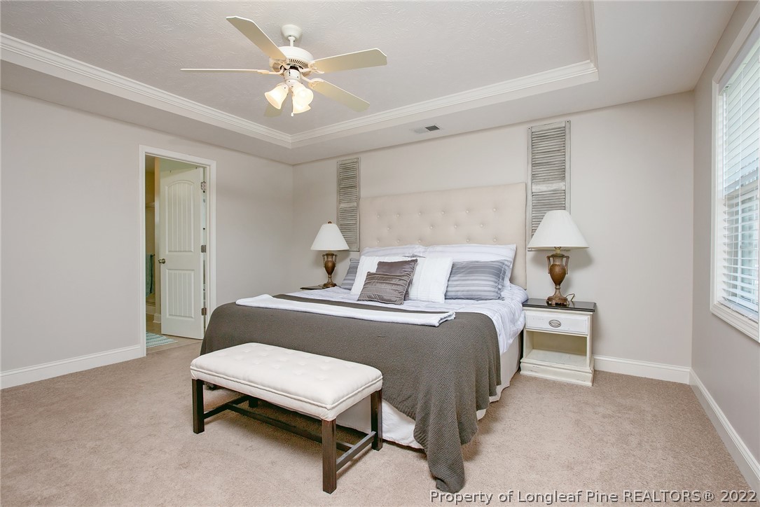 71 Germantown Road Cameron, NC 28326 - Photo 32 of 36 a bedroom with a bed and a chandelier