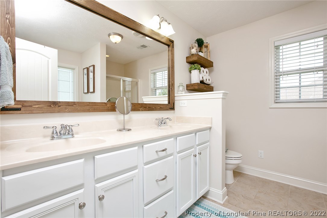 71 Germantown Road Cameron, NC 28326 - Photo 34 of 36 a bathroom with a sink and a mirror