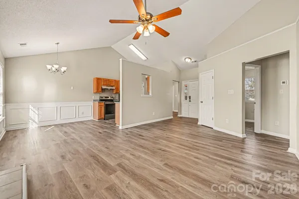 a view of a kitchen with wooden floor and a ceiling fan