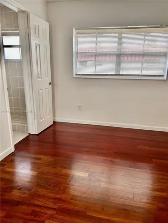 a view of wooden floor and windows in a room