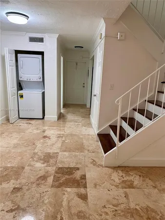 a view of a livingroom with wooden floor and stairs