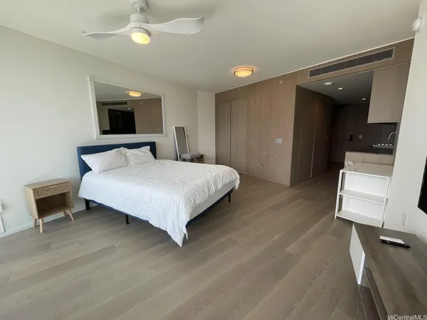 a bedroom with a bed and a chair