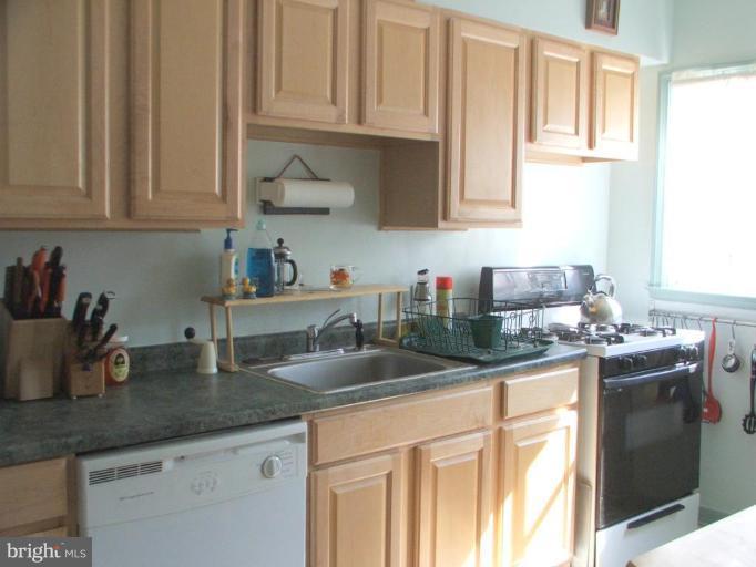 622 Braeside Road Baltimore, MD 21229 - Photo 7 of 17 a kitchen with granite countertop a sink a stove and cabinets