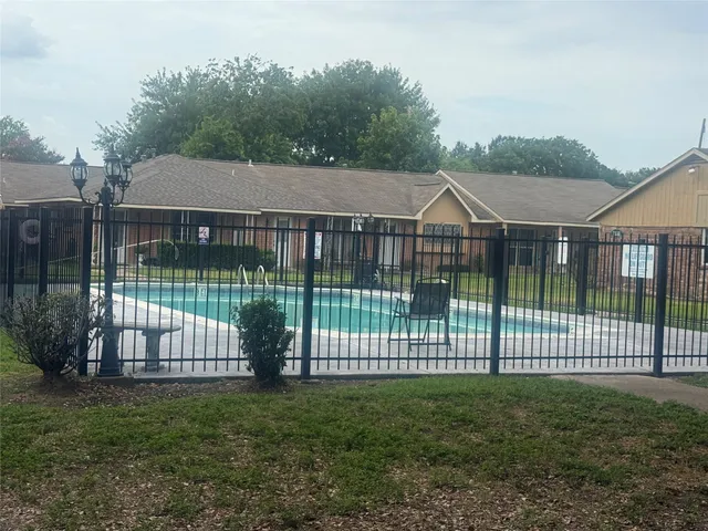 a backyard of a house with lots of green space and fountain