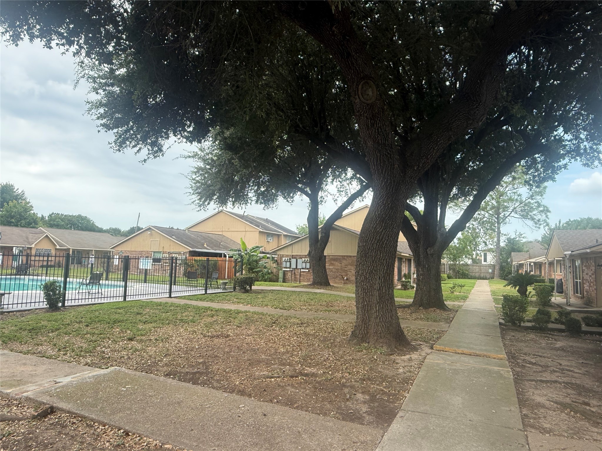 0 Burke Road Pasadena, TX 77504 - Photo 18 of 18 a backyard of a house with lots of green space and fountain