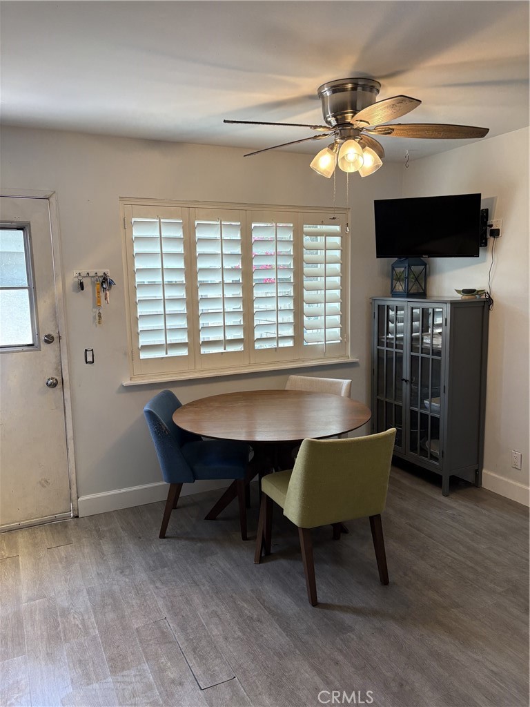 4731 Rey Drive, Unit 133 Huntington Beach, CA 92649 - Photo 12 of 31 a view of a dining room with furniture window and wooden floor