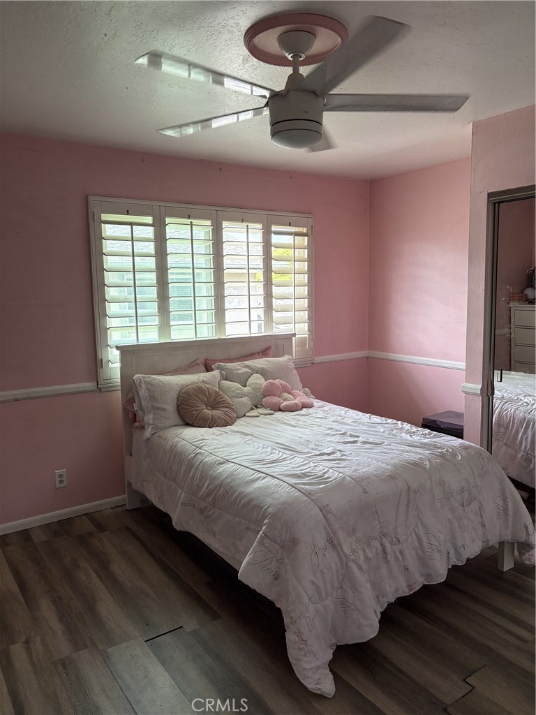 4731 Rey Drive, Unit 133 Huntington Beach, CA 92649 - Photo 15 of 31 a bedroom with a bed and a ceiling fan