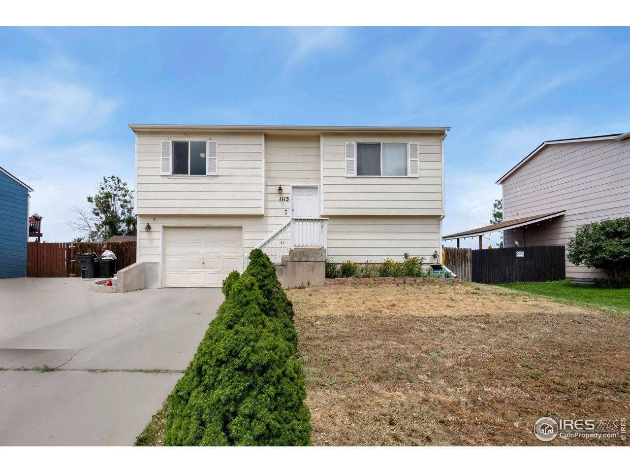 1113 East 24th Street Road Greeley, CO 80631 - Photo 1 of 25 a front view of a house with a yard