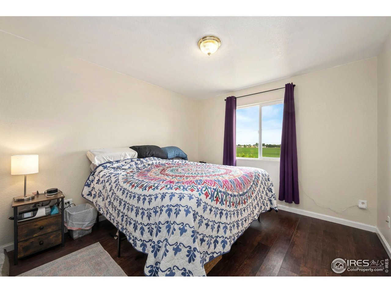 1113 East 24th Street Road Greeley, CO 80631 - Photo 11 of 25 a bedroom with a bed and a window