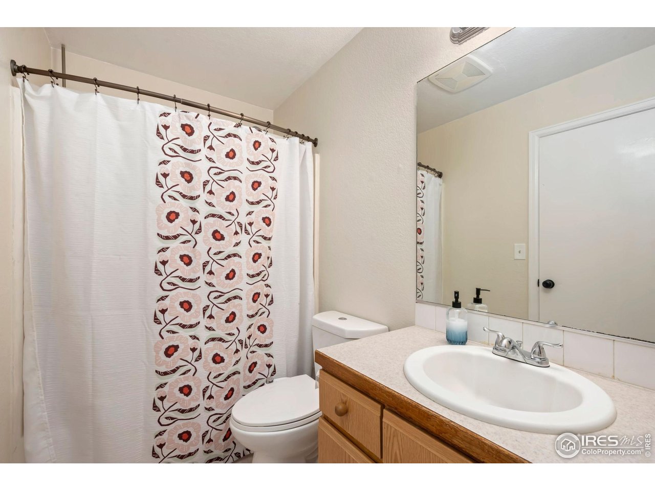 1113 East 24th Street Road Greeley, CO 80631 - Photo 16 of 25 a bathroom with a sink toilet and shower