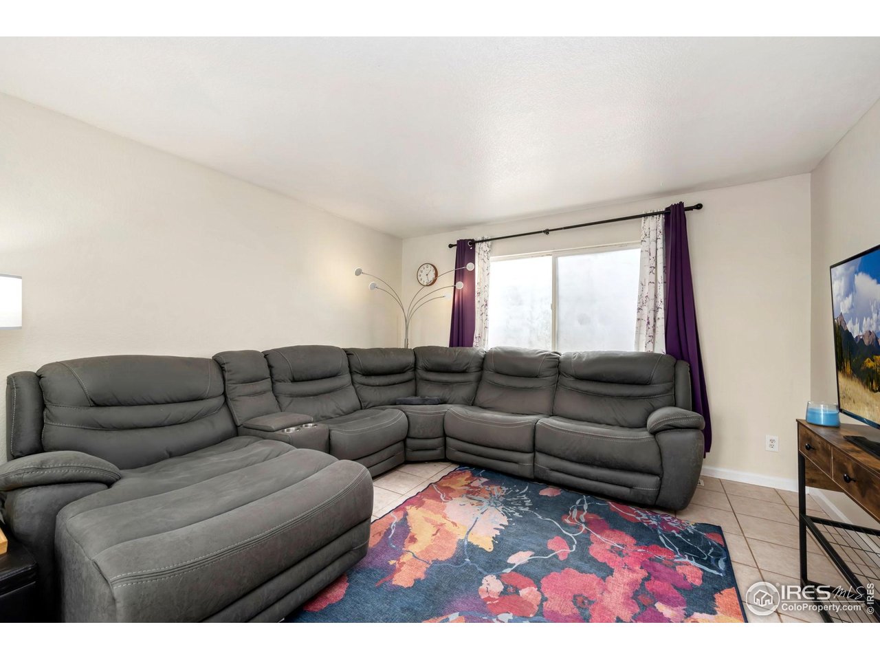 1113 East 24th Street Road Greeley, CO 80631 - Photo 4 of 25 a living room with furniture and a large window