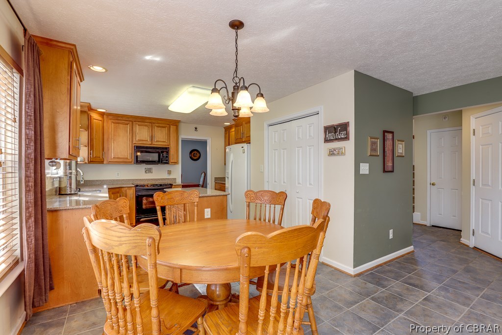 7211 Woody Road Gloucester, VA 23061 - Photo 10 of 24 Large eat in kitchen with ceramic tile that opens into the family room.