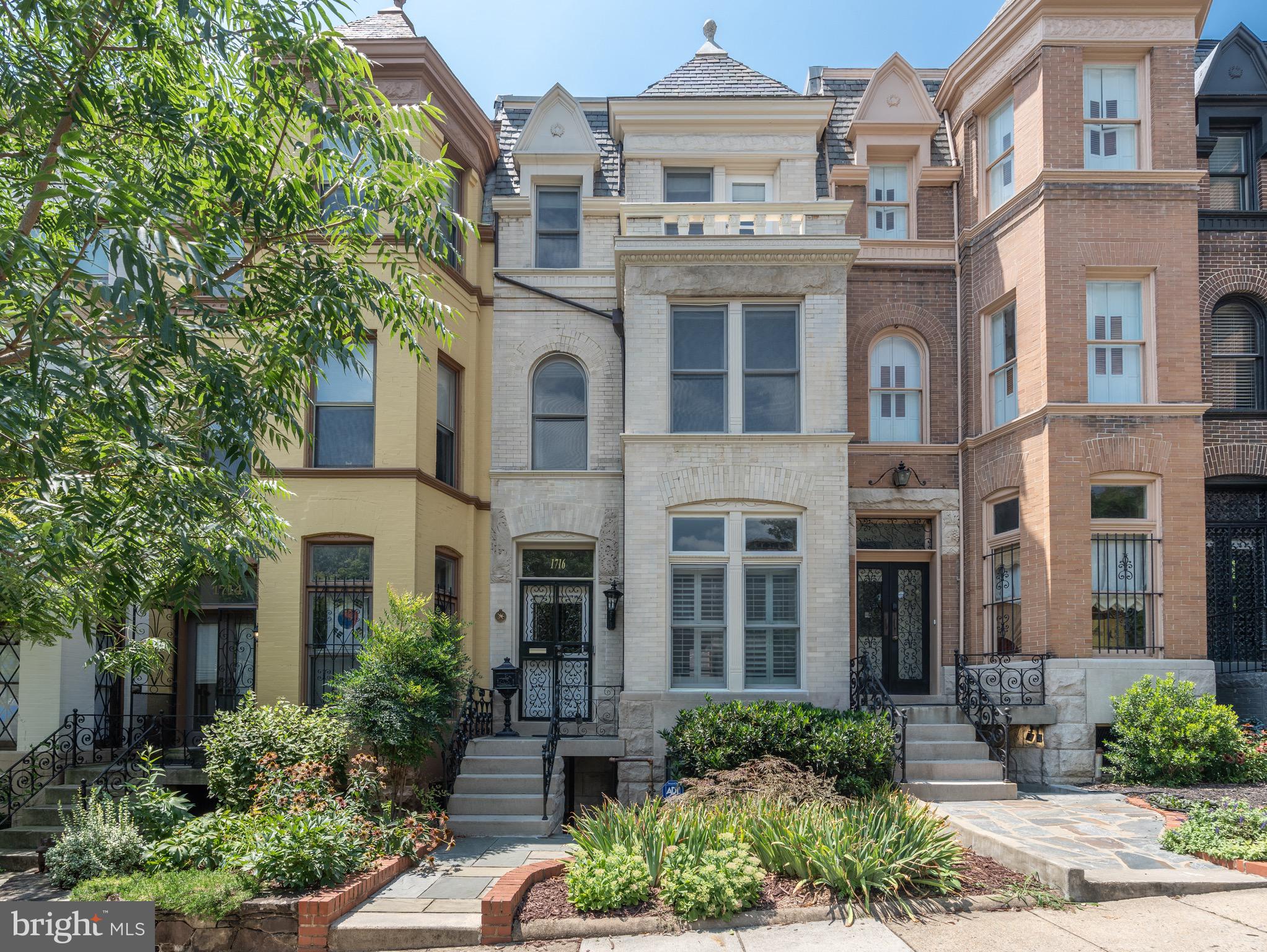 a view of a brick building next to a yard