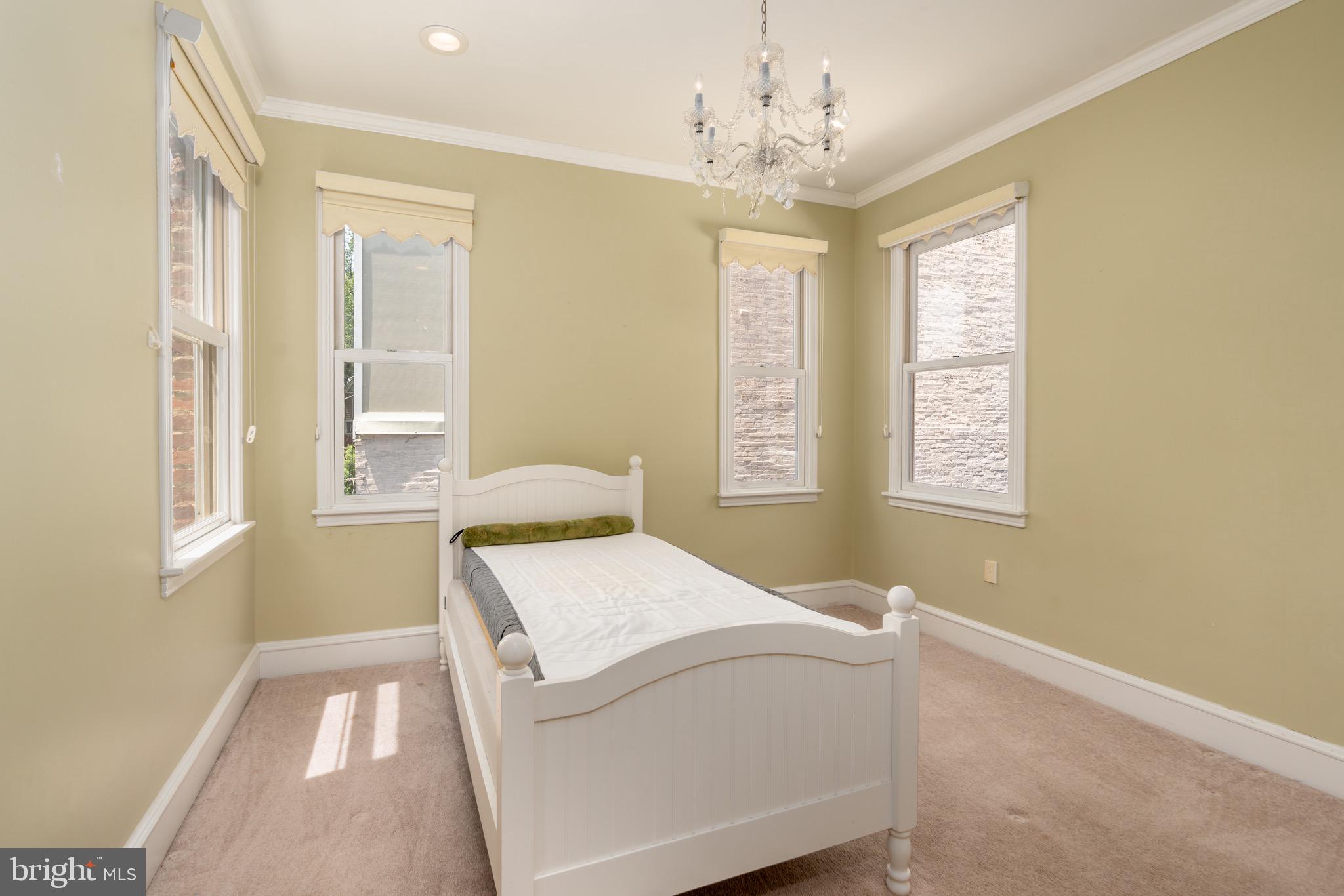 1716 22nd Street Northwest Washington, DC 20008 - Photo 20 of 40 a bedroom with a bed and windows