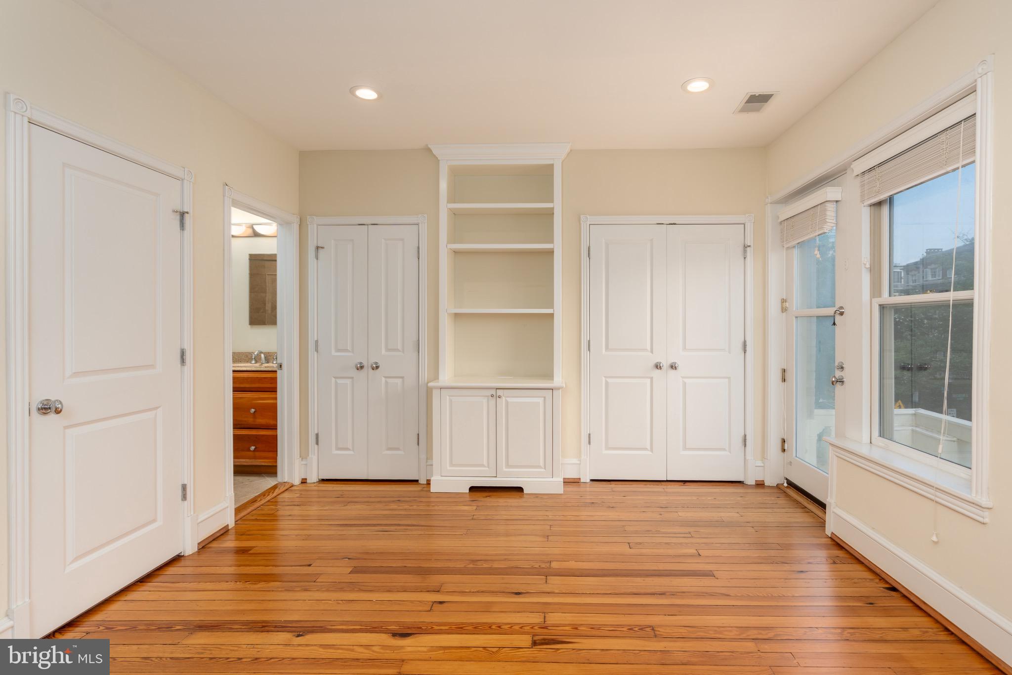 1716 22nd Street Northwest Washington, DC 20008 - Photo 23 of 40 a view of an empty room with wooden floor and window