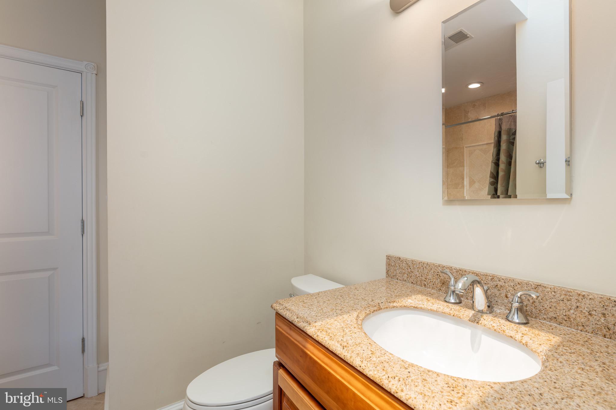 1716 22nd Street Northwest Washington, DC 20008 - Photo 28 of 40 a bathroom with a sink toilet and mirror