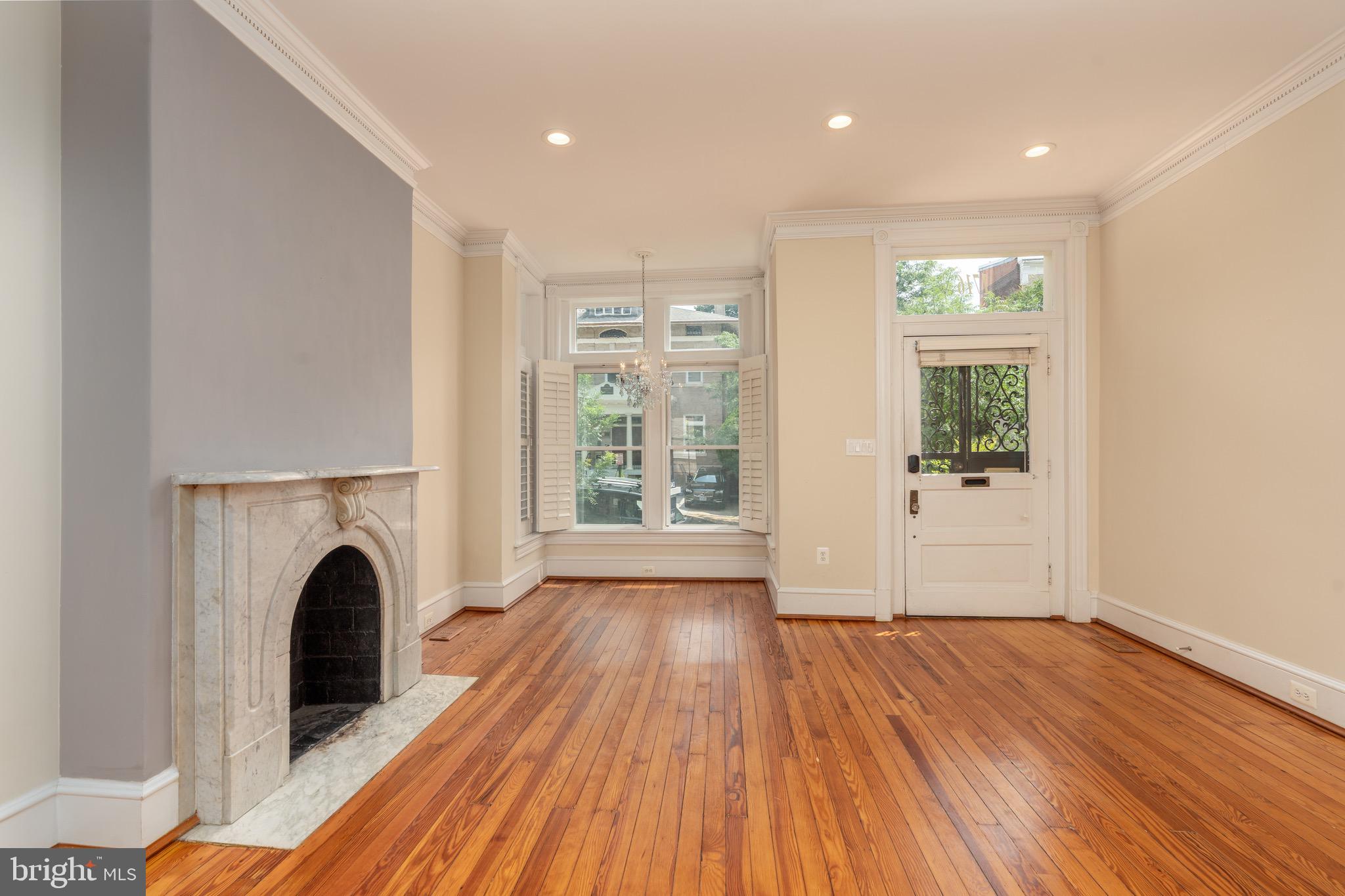 1716 22nd Street Northwest Washington, DC 20008 - Photo 3 of 40 a view of a big room with wooden floor a fireplace and windows