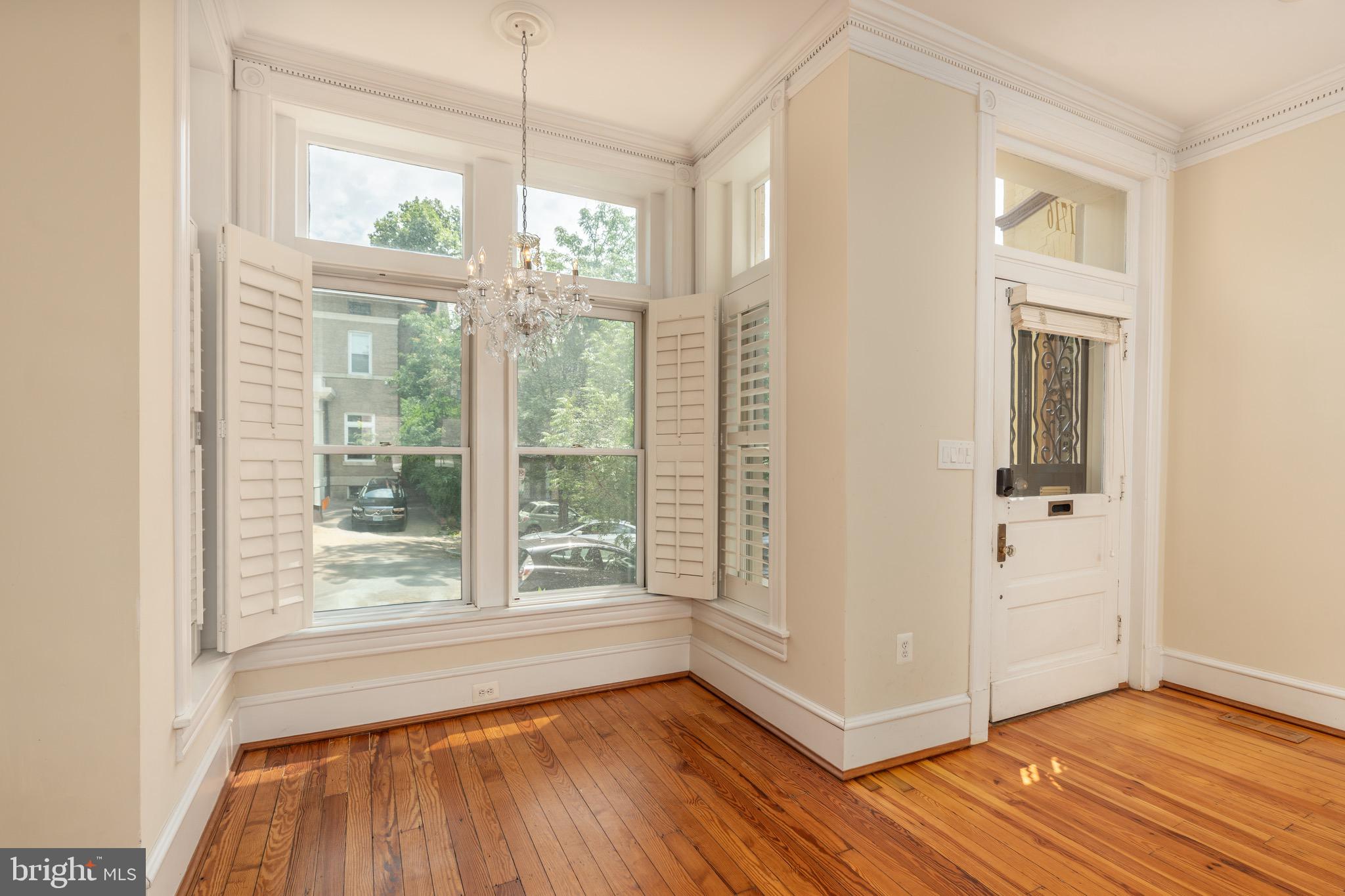 1716 22nd Street Northwest Washington, DC 20008 - Photo 4 of 40 a view of an empty room with glass door and wooden floor
