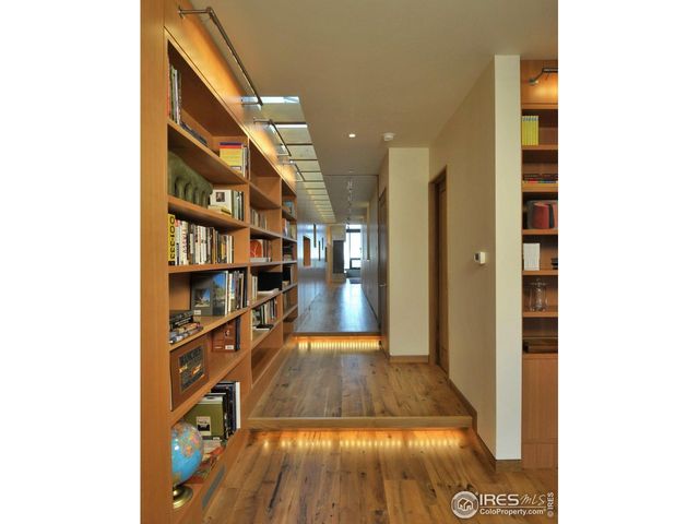 a view of a hallway with wooden floor and entryway