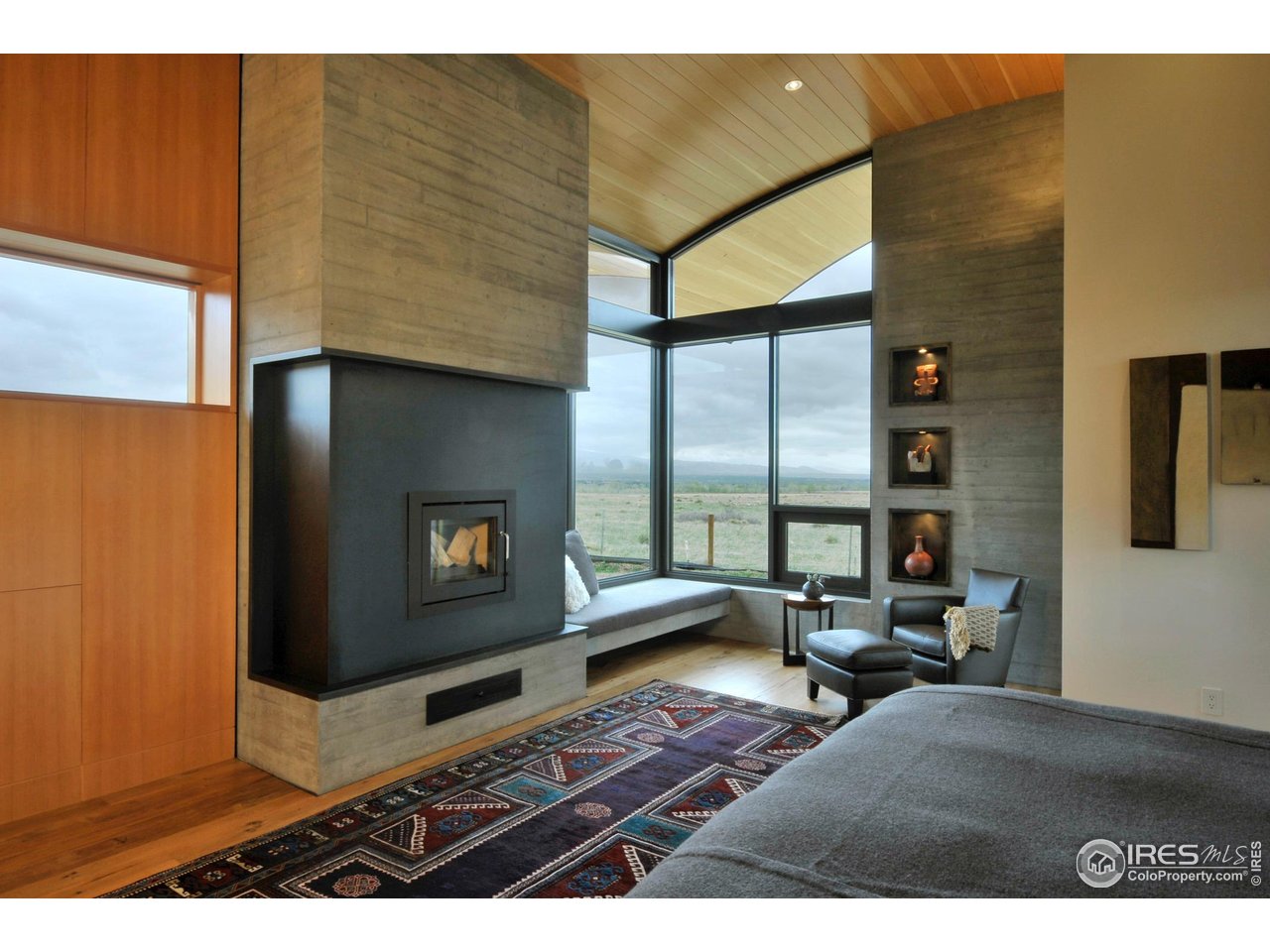1355 South Cherryvale Road Boulder, CO 80303 - Photo 14 of 40 a living room with couches bookshelf and a flat screen tv