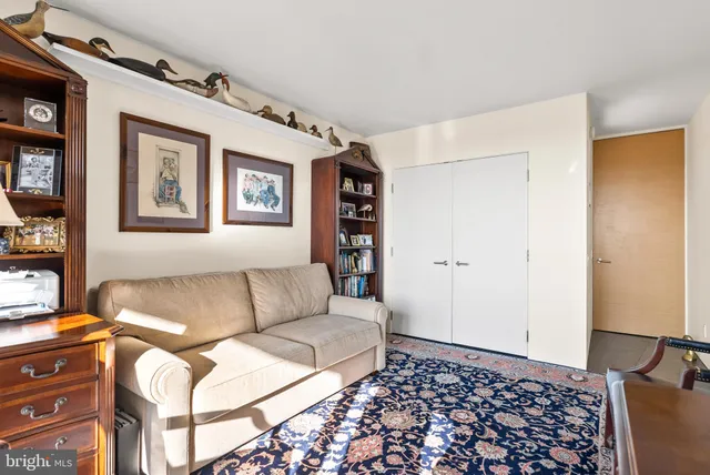 a living room with furniture and painting on the wall