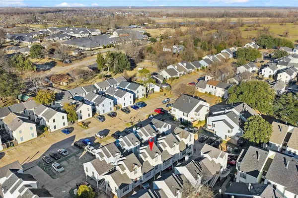 a view of a house with a barbeque and wooden fence