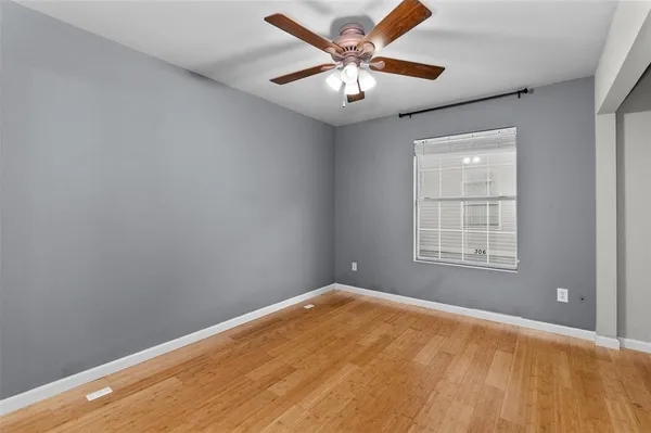 wooden floor in an empty room with a bathroom