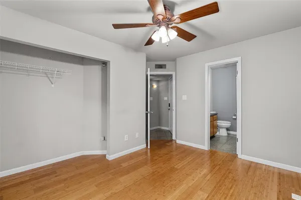 a bathroom with a granite countertop sink toilet a mirror and shower
