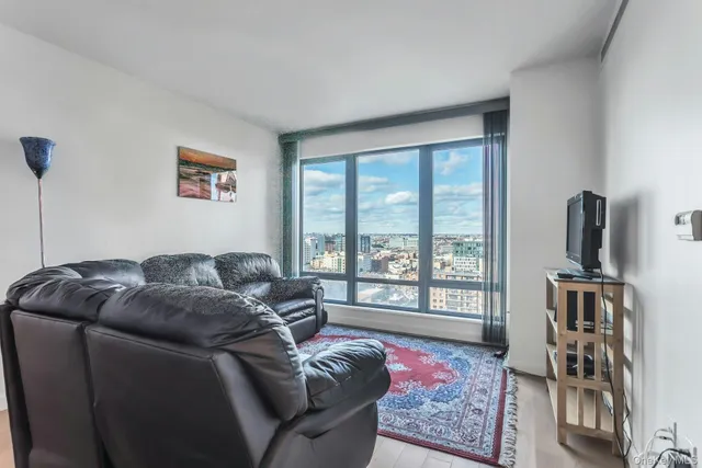 a living room with furniture or couch and a large window
