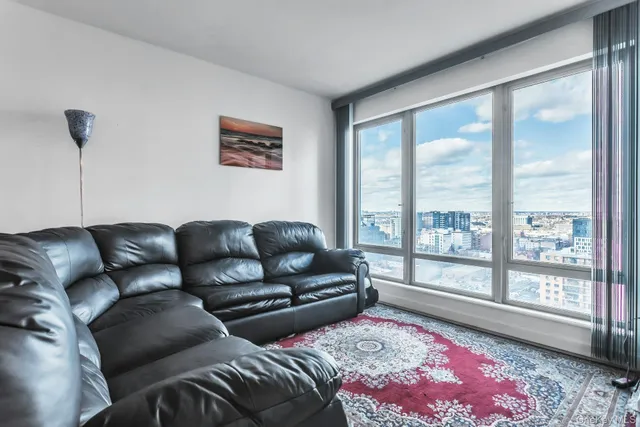 a living room with furniture and a large window