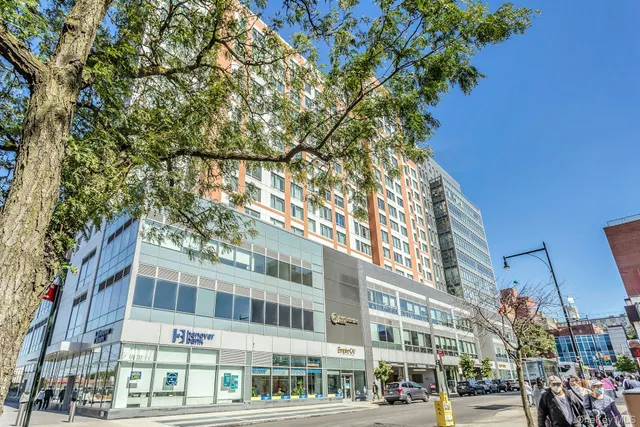 a city street lined with buildings and trees