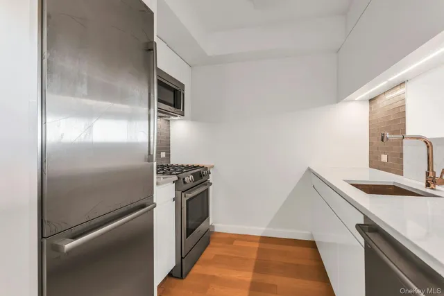 a kitchen with granite countertop stainless steel appliances and wooden cabinets