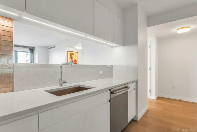 a kitchen with a sink and a refrigerator