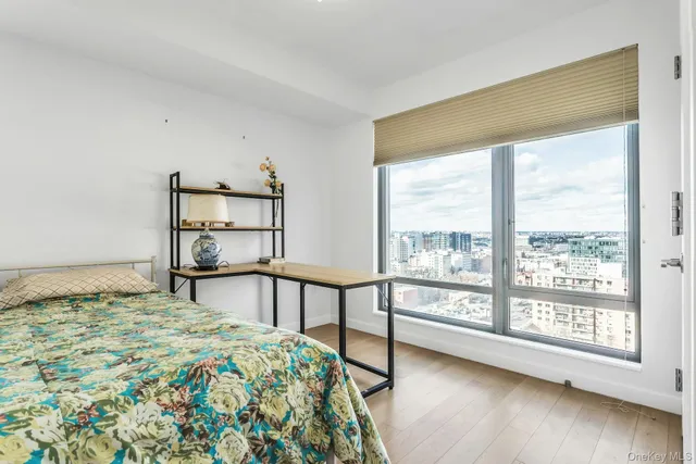 a bedroom with a bed and a large window