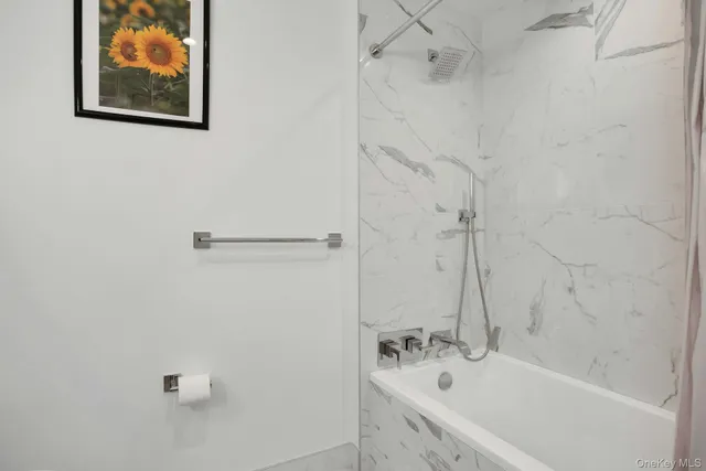 a bathroom with a bathtub and shower