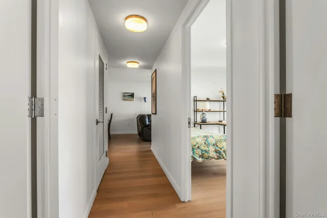 a view of a hallway with windows and stairs