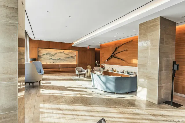 a view of living room with a floor to ceiling window and couch