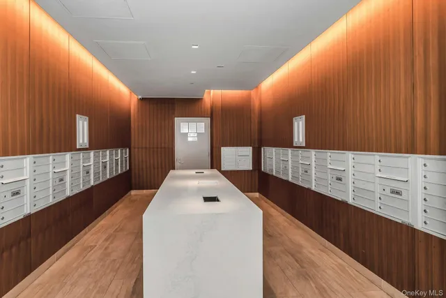 a large kitchen with stainless steel appliances a large counter top a stove and a wooden floors